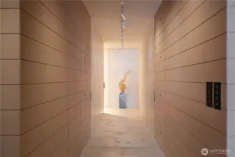 Dramatic main hallway with hidden access to a three quarter bathroom, flex guest space and primary suite.