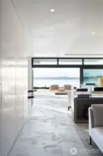 Soft concrete floors and venetian plaster ceilings and walls reflect the light from Lake Washington. Hidden office on the left side behind panel doors, library sitting area to the right.