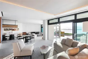 Living room area looking across to the dramatic Bronze and cast concrete fireplace. Spaces feature both radiant heat, forced air and A/C as well as several acoustically treated conversation areas and invisible built-in audio speakers throughout.