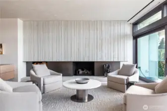 Modern formed concrete and Bronze fireplace. Gas fired and wood burning.