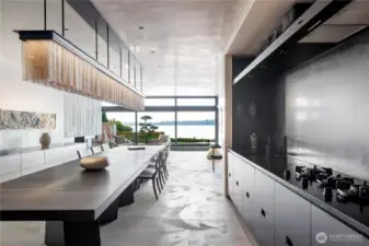 Center Island dinning table and prep space, Gagganeu cook top, Miele and Liebherr appliances.