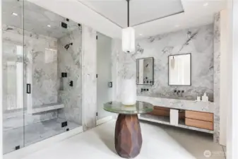 Primary bathroom suite finished in solid Italian Marble, center island table, steam shower.