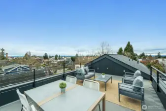 Spacious rooftop deck with Sound and Olympic views. On a clear day, the mountains are even more prominent.