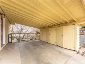 Covered carport with additional storage space and convenient access to the home.
