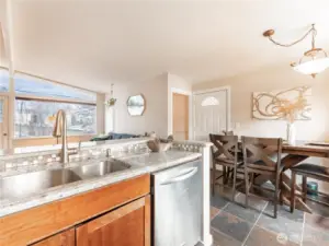 Spacious mid-century living room with large windows and natural light.