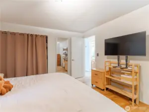 Main level bedroom with hardwood floors and natural light.