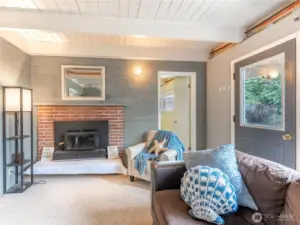 Lower level family room with second wood-burning fireplace.