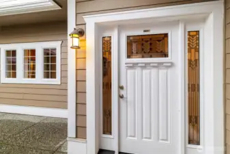 Inviting front entrance featuring a covered entry and decorative glass door, creating a warm first impression as you arrive home.