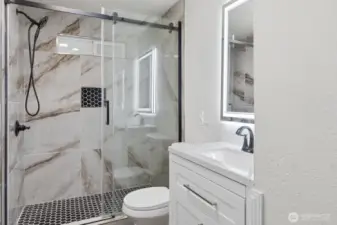 2nd bathroom for added convenience also with a tile shower, new vanity, and lit mirror.