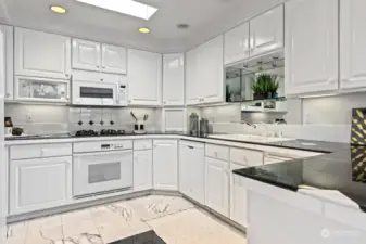 Gas cooktop, ample cabinets and tile countertops