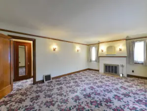 The living room with its wood burning fireplace.