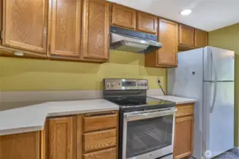 Another view of kitchen continues the with upper and lower cabinets.