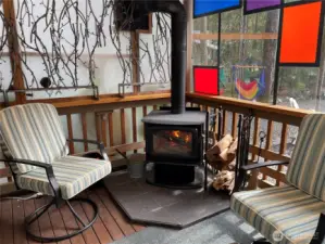 Step up on the partially enclosed deck, and enjoy the warmth of the woodstove.