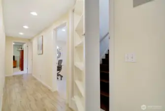 Staircase to lower level, w/bookshelf door