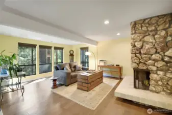 Formal Living Room w/gorgeous stone fireplace, engineered hardwood floors