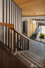 The curving wood handrail is a work of art in itself!