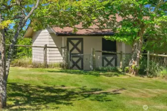 The 2-stall barn has a tack room and an attached chicken coop!