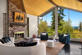 The spacious upper living room has a new cedar ceiling and new flooring. Relax in the evening with the fire burning as you watch the world settle in for the night.