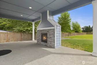 Great room opens to covered patio with cozy gas fireplace.