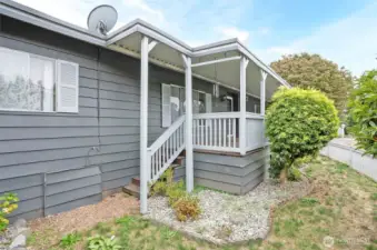 Relax on the covered front porch overlooking the fenced yard—perfect for pets.