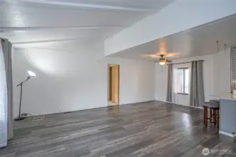 Looking from the living area toward the primary suite door, notice the gorgeous LVP flooring.