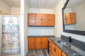 Updated primary ensuite boasting a walk-in shower and extra storage cabinets.