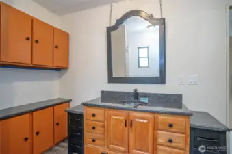 Primary ensuite from a different angle, showcasing the stunning sink and cabinets.