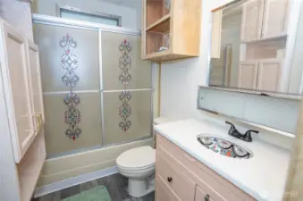 Guest bathroom with a stunning sink and full amenities.