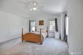 The spacious primary bedroom has vaulted ceilings.