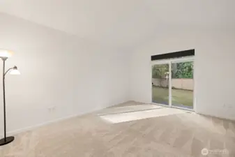 Primary bedroom with slider to rear yard and patio