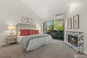Master bedroom with its own fireplace and outside deck, vanity, walk-in closet, and shower are to the left.  This particular condo owner installed the HOA approved mini split AC/heat system for year round comfort