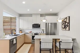 Well-appointed kitchen with SS appliances, under-cabinet lighting, and custom cabinetry.