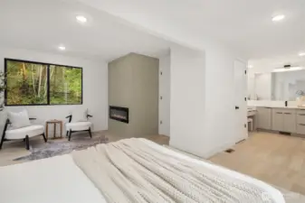 Cozy primary suite with fireplace and seating area