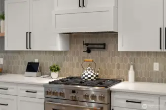 The tiled mosaic backsplash fills the kitchen with warmth.