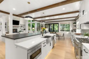Reclaimed wood beams throughout the kitchen and dining spaces.