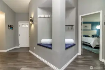 This convenient angled nook has a sitting area on both sides and hooks to hang jackets. etc