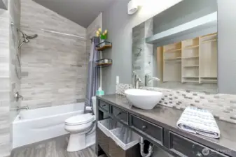 This main full bathroom includes a lovely tile surround & tile backsplash as well as updated fixtures.