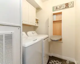 This laundry room includes newer washer/dryer and a custom ironing board built-in!