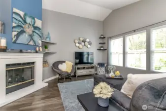 Raised ceilings, an updated gas fireplace and additional shelving/cubbies contribute to the ambience of this living area.