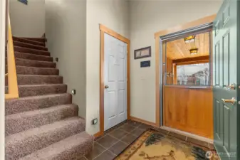 Front entry, with screen door and convenient access to the attached one-car garage.