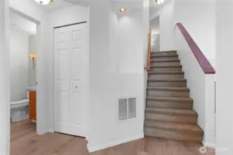 Stairs on Main Level to Upper Level, near half bath and storage!