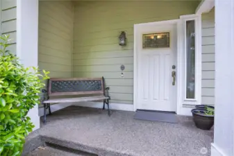 Inviting front porch! Bench conveys.