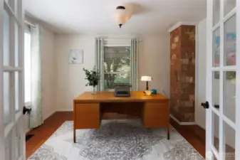 Main floor office featuring French doors adjacent to the dining room.