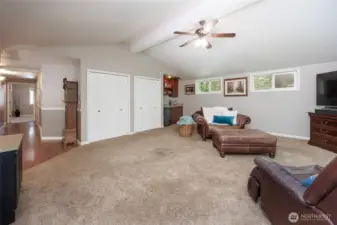 The main floor recreation room offers a wet bar and plenty of windows to view the arboretum-like back yard.