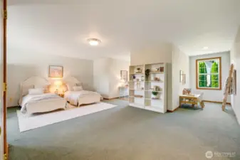 Spacious upper-level bedroom that could serve as a second primary suite, featuring a connected bathroom, generous walk-in closet, and charming dormer windows for added architectural character.