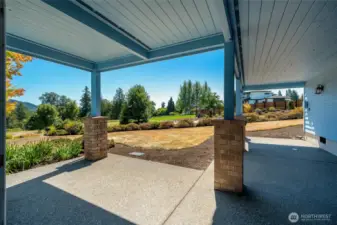 Covered patio with space to relax and enjoy views of the yard and surrounding greenery.