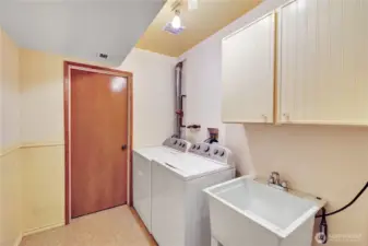 Lower laundry room with huge storage closet.