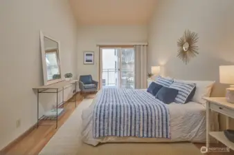 Souring ceilings and sliding glass door leads to the deck.