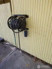 Key box is on water hose on front of Unit 205