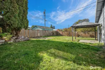 Expansive fenced yard with level lawn and ample space for outdoor living or future garden projects.